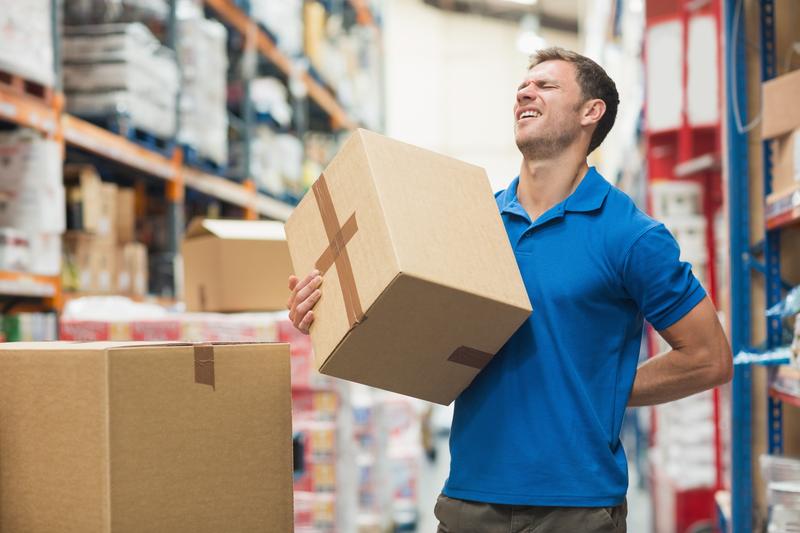 Man carrying package with back pain